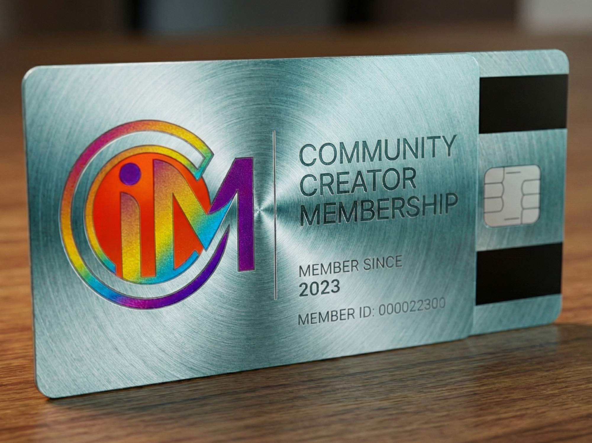 Metallic card with colorful logo and text on a wooden surface